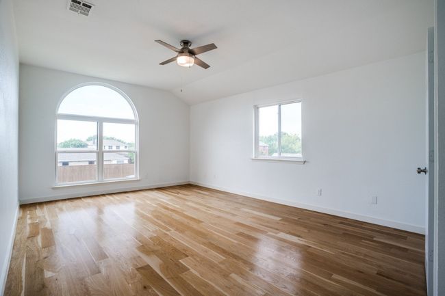 Spare room with vaulted ceiling, a ceiling fan, light wood-style flooring, and baseboards | Image 27