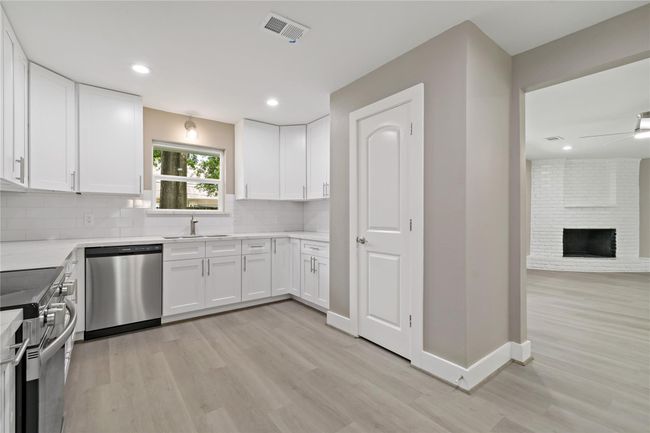 Kitchen view of window overlooking backyard. | Image 26