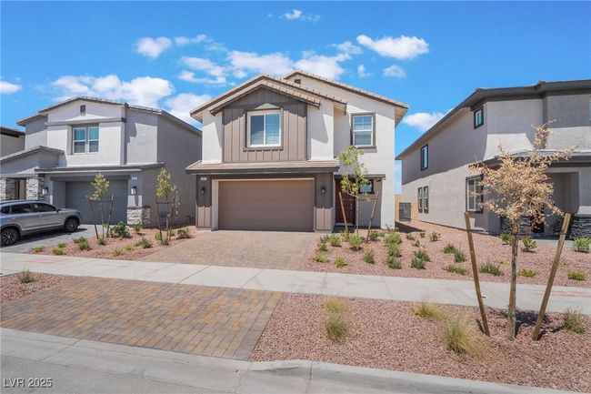 View of front of property with an attached garage, board and batten siding, and decorative driveway | Image 4