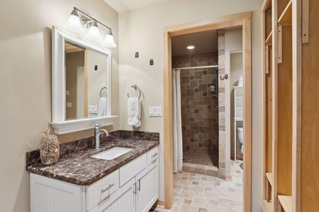 Super convenient lower level 3/4 bathroom w/ beautiful tiled shower and fabulous lockers space beach towels! Home was built for lake days!! | Image 39