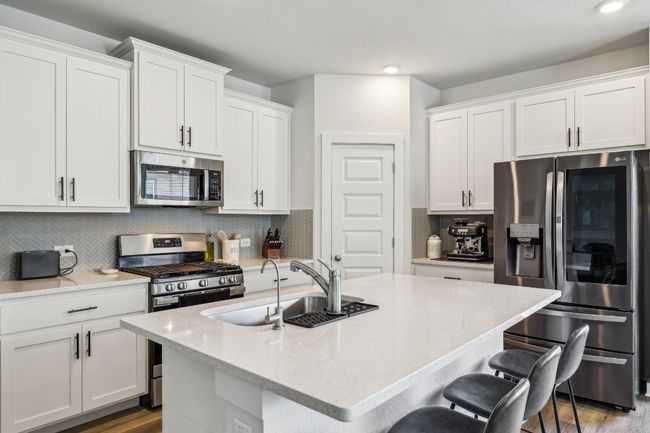 Cooking just got a whole lot easier with a center island, custom cabinetry, and a walk-in pantry. | Image 19