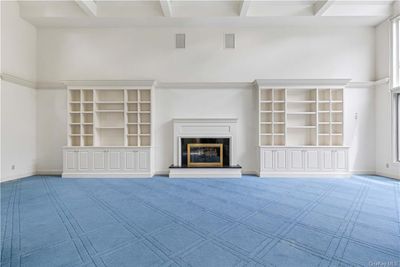 Another view of the grand Living Room showing fireplace and built-ins | Image 3