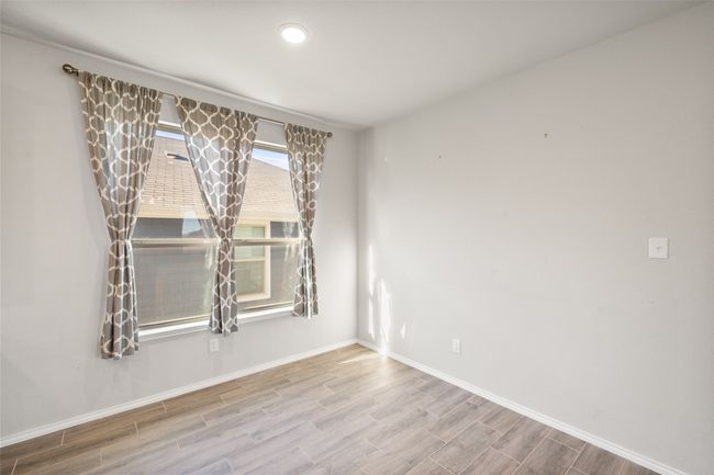 Spare room featuring baseboards and wood finished floors | Image 29