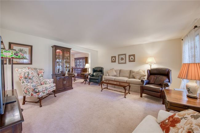 Living room with newer carpet and tons of natural sunlight | Image 5