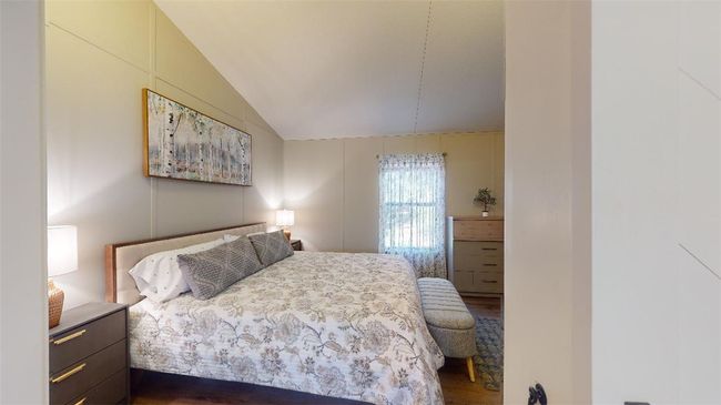 Bedroom featuring lofted ceiling and dark wood-style flooring | Image 22