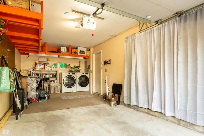 garage featuring washer and clothes dryer and a garage door opener | Image 32