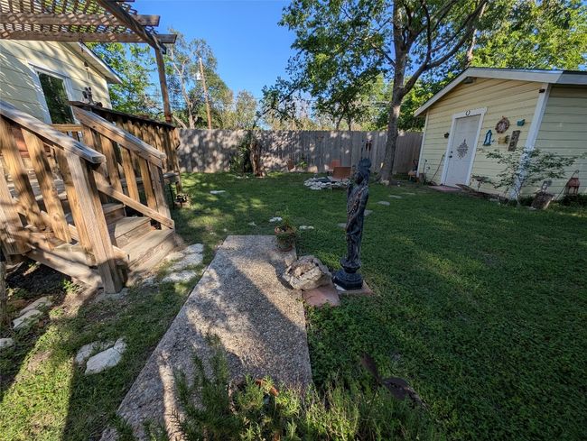 View of yard with a pergola, an outbuilding, a fenced backyard, and a deck | Image 25