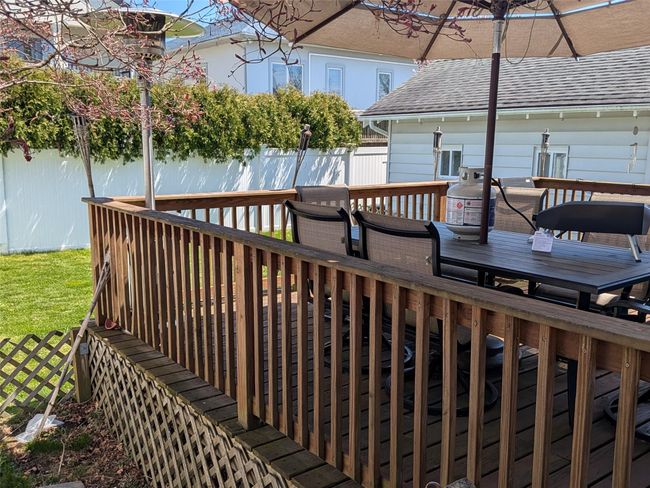Deck with outdoor dining area and a fenced backyard | Image 4