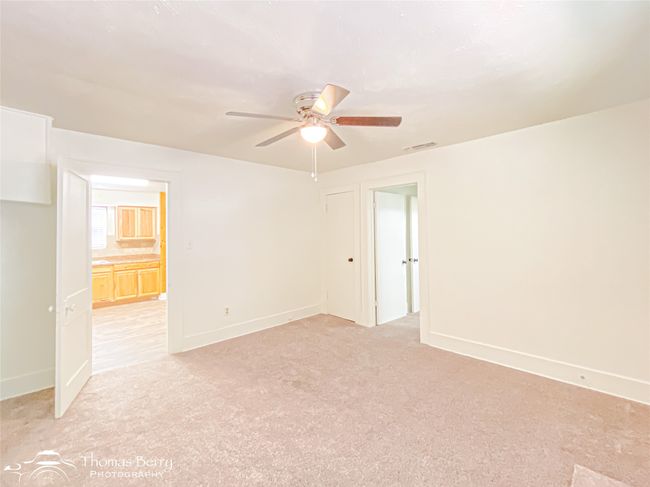 Empty room featuring a ceiling fan and light carpet | Image 26