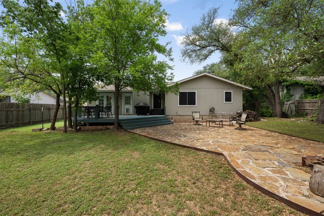 Back of house featuring a lawn, a fenced backyard, a patio, and a deck | Image 28
