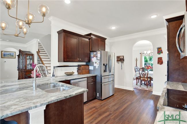 Kitchen with view into the dining room and into the family room | Image 11