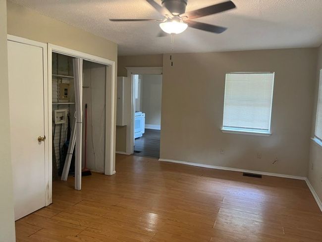 Unfurnished bedroom with light wood-type flooring, a closet, a ceiling fan, and a textured ceiling | Image 13