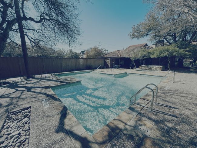 Community pool with a fenced backyard and a patio | Image 18