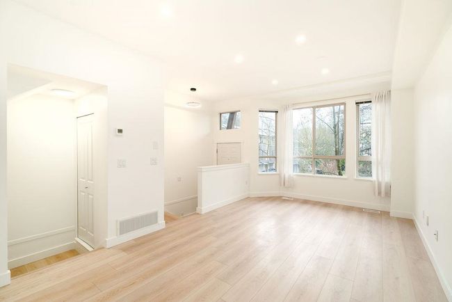 Empty room featuring light wood finished floors, baseboards, visible vents, and recessed lighting | Image 11