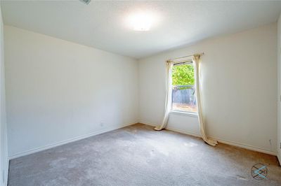 Bedroom with light carpet and a textured ceiling | Image 3