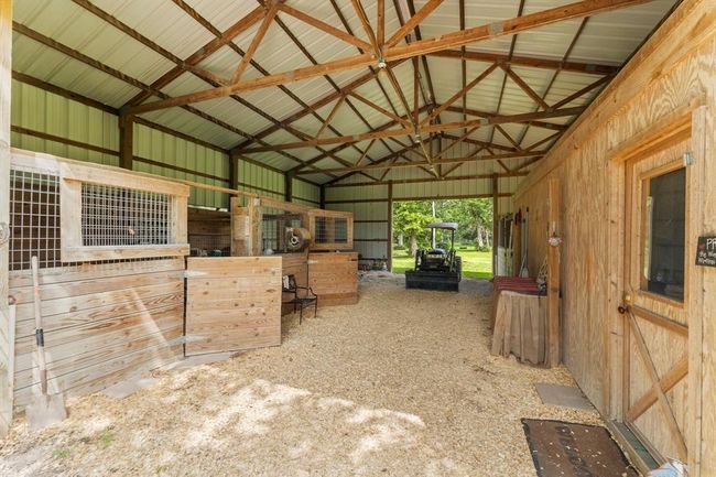 Here is your true horse barn on property! 3 stalls ready to go for your best horses. Small apartment inside the barn as well! | Image 41
