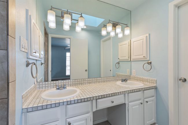 primary Full bathroom with a skylight, a sink, and double vanity | Image 19