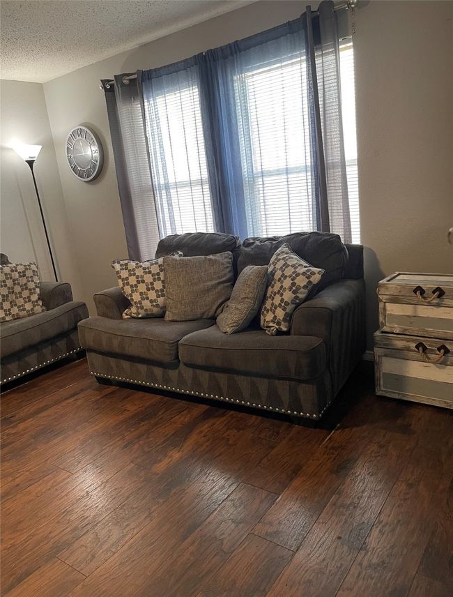 Living area with wood-style flooring and ceiling fan | Image 6