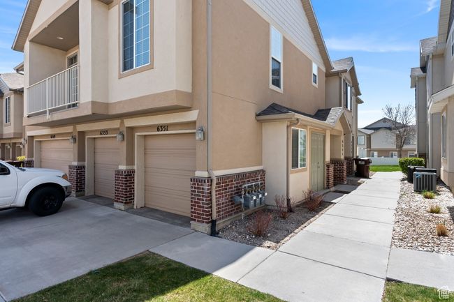 View of property exterior featuring central AC unit, a garage, stucco siding, and driveway | Image 20