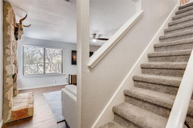 Stairway with wood finished floors, ceiling fan, and baseboards | Image 12