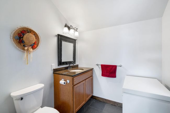 Gorgeous slate flooring ties the mudroom with the 1/2 bath on the main floor | Image 23