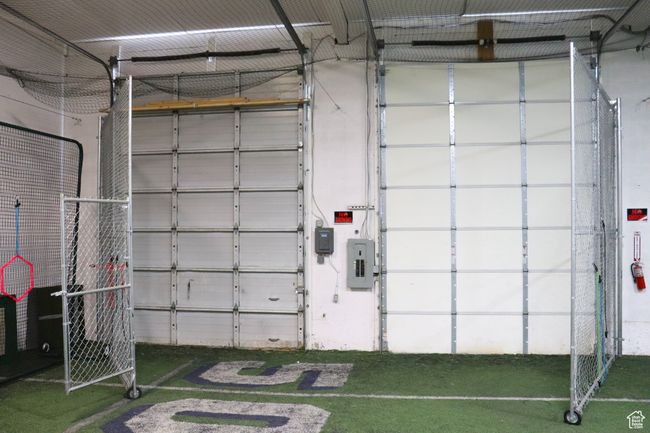 Gates in front of garage doors swing open. | Image 12