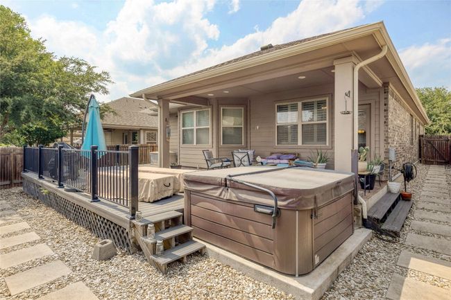 Back of property featuring a hot tub and a wooden deck | Image 23