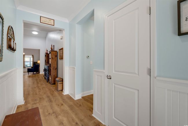 Hallway with ornamental molding and light hardwood / wood-style floors | Image 9