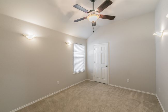 Third bedroom featuring baseboards, lofted ceiling, and a ceiling fan | Image 15