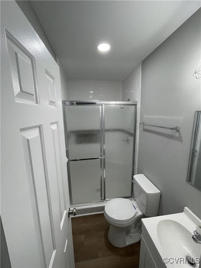 Full bath with wood finished floors, vanity, a stall shower, and recessed lighting | Image 5