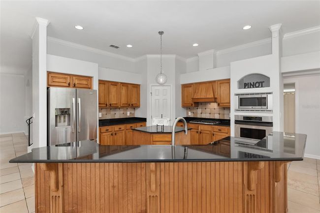SPACIOUS KITCHEN WITH GRANITE COUNTERS AND LARGE SEATING BAR AREA | Image 18