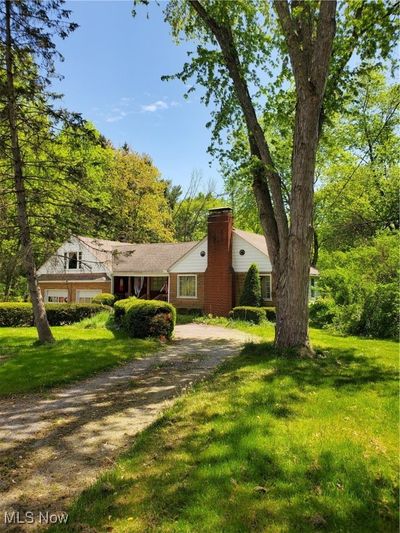 View of front of house featuring a front yard and a garage | Image 1