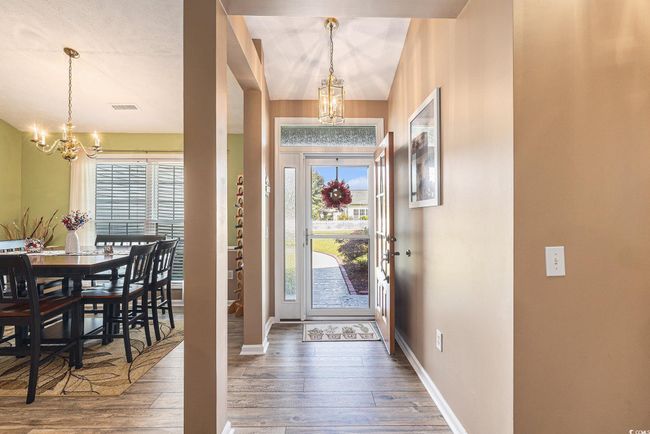 Entrance foyer featuring a chandelier, baseboards, and healthy amount of natural light | Image 9