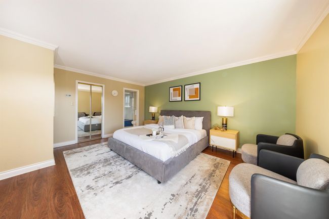 Bedroom featuring baseboards, wood finished floors, and crown molding | Image 30