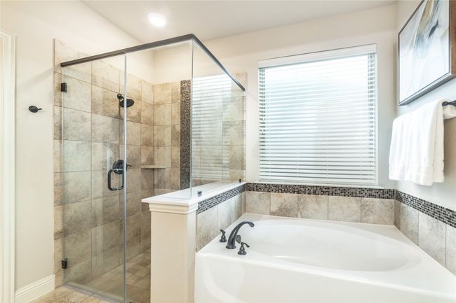 Bathroom featuring a garden tub and a stall shower | Image 18
