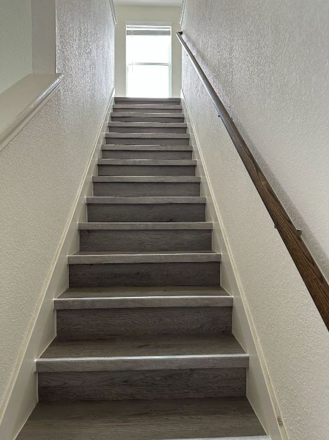 Stairway featuring a textured wall and wood finished floors | Image 19