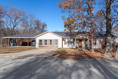 Home has a three car garage, sits on two lots and has an inground saltwater pool. Many updates, newer roof and oversized, newer HVAC, too! | Image 1