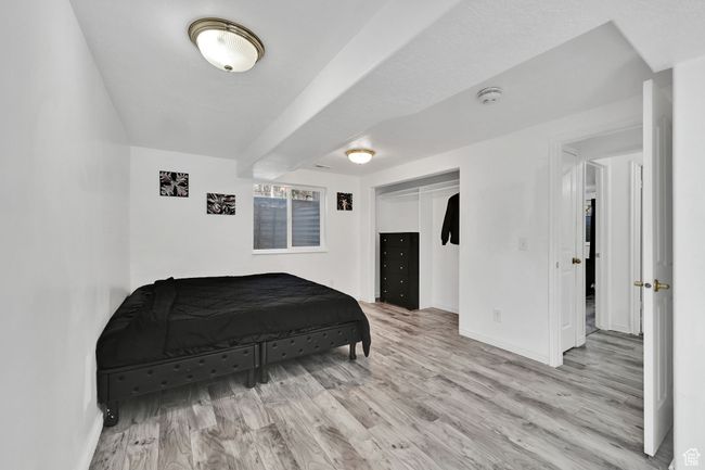 Bedroom with baseboards, wood finished floors, and a closet | Image 29