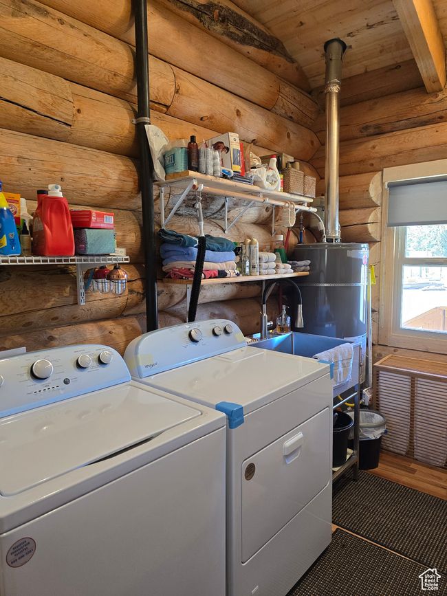 Laundry area featuring water heater, separate washer and dryer, laundry area, and wood ceiling | Image 113