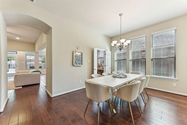 With its warm wood floors and natural light, the dining room adds a welcoming and elevated touch to the heart of the home | Image 7