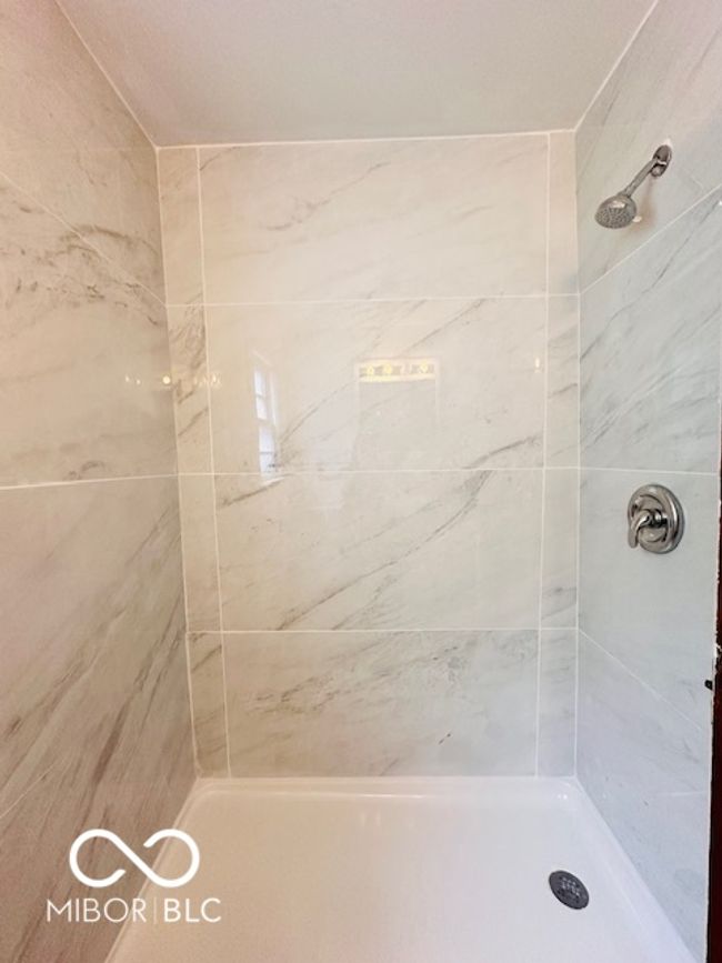 full bathroom featuring a tile shower | Image 8