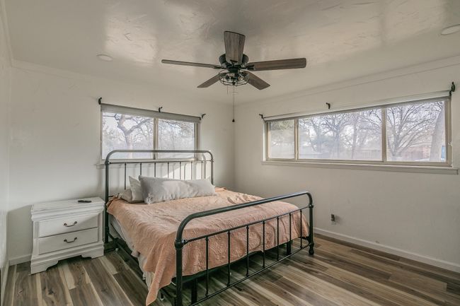 Bedroom featuring wood finished floors and a ceiling fan | Image 17