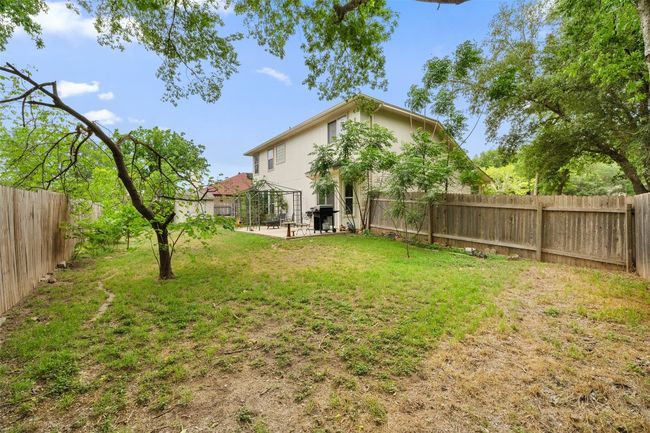 View of yard featuring a gazebo, a fenced backyard, and a patio | Image 40