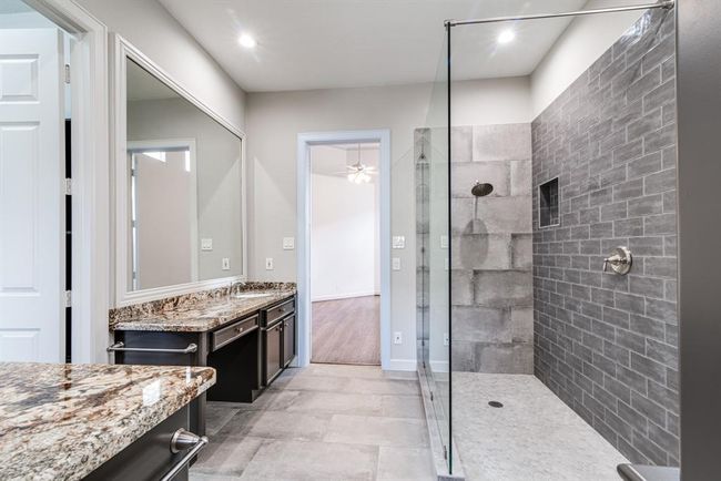 Enjoy this gorgeous custom shower in the primary en suite. | Image 9