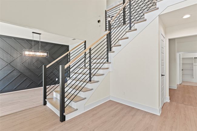 Staircase with wood finished floors, a chandelier, and recessed lighting | Image 4