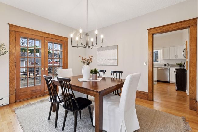 Find eye-catching overhead lighting and French doors to the deck. The kitchen is mere steps away for your serving ease. | Image 11