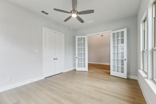 Unfurnished room featuring french doors, light wood finished floors, and a ceiling fan | Image 6
