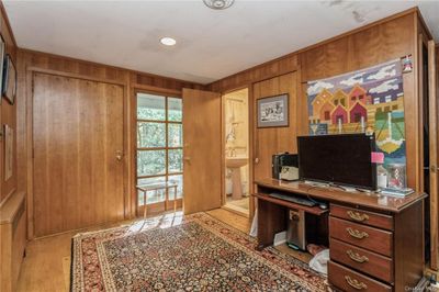 Home office featuring sink and wooden walls | Image 2