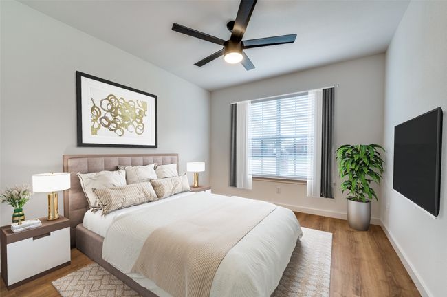 Bedroom featuring ceiling fan, wood finished floors, and baseboards | Image 20