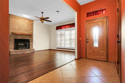 Foyer entrance with hardwood / wood-style floors, a fireplace, and ceiling fan | Image 3